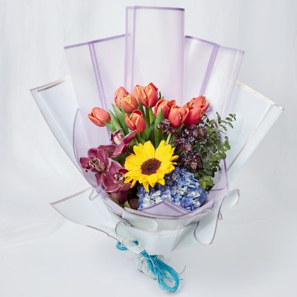 vibrant mixed flowers wrapped bouquet: Graduation Flowers